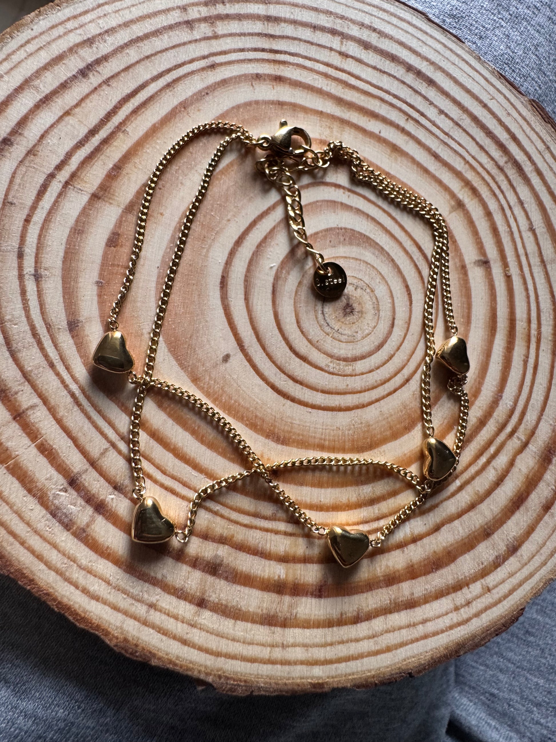 Gold chain necklace on a wooden surface
