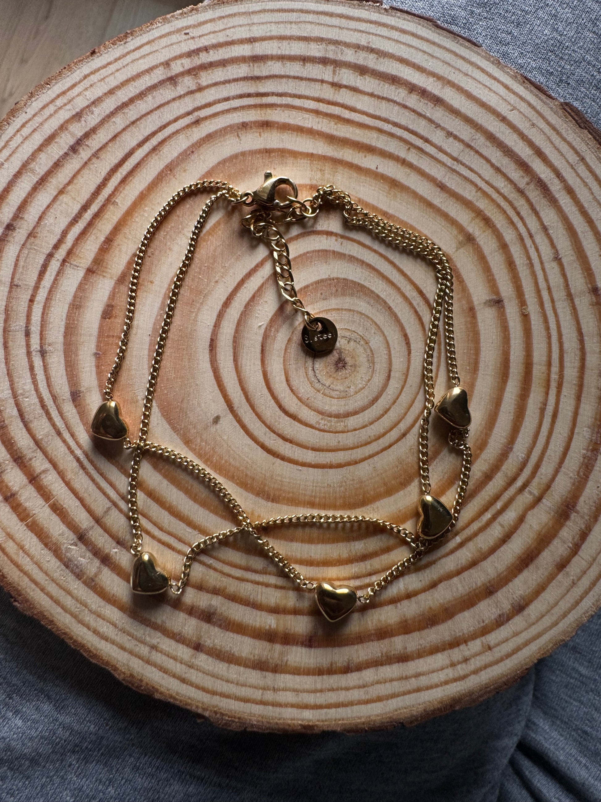 Gold bracelet on a wooden surface
