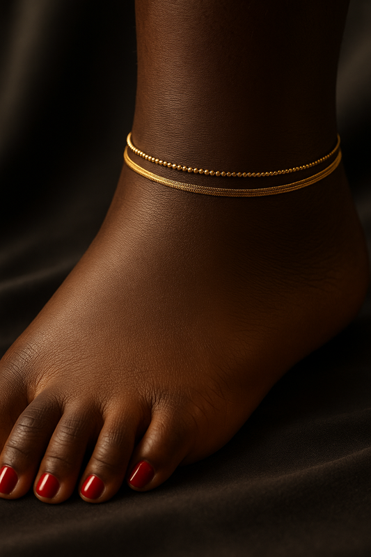 Ankle with gold anklets on a dark background