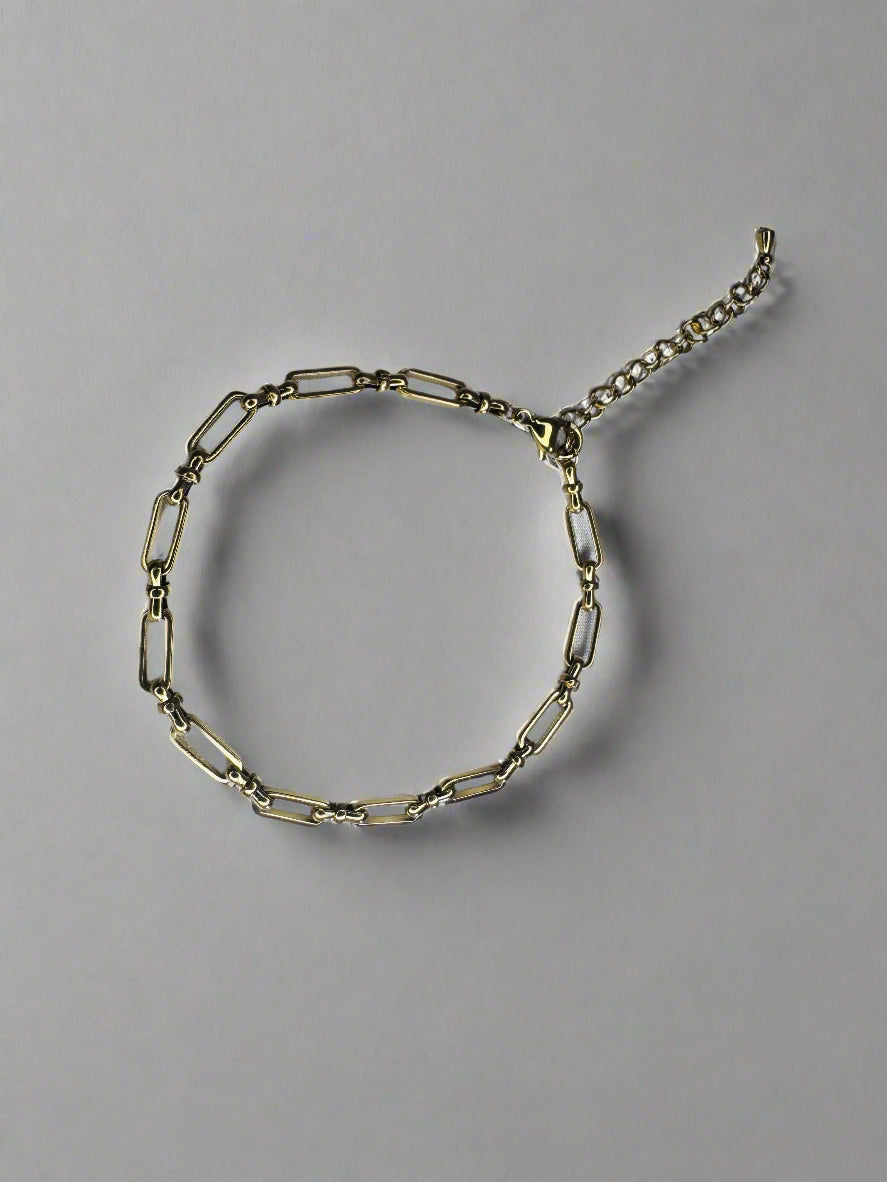 Gold bold link anklet on a light gray background