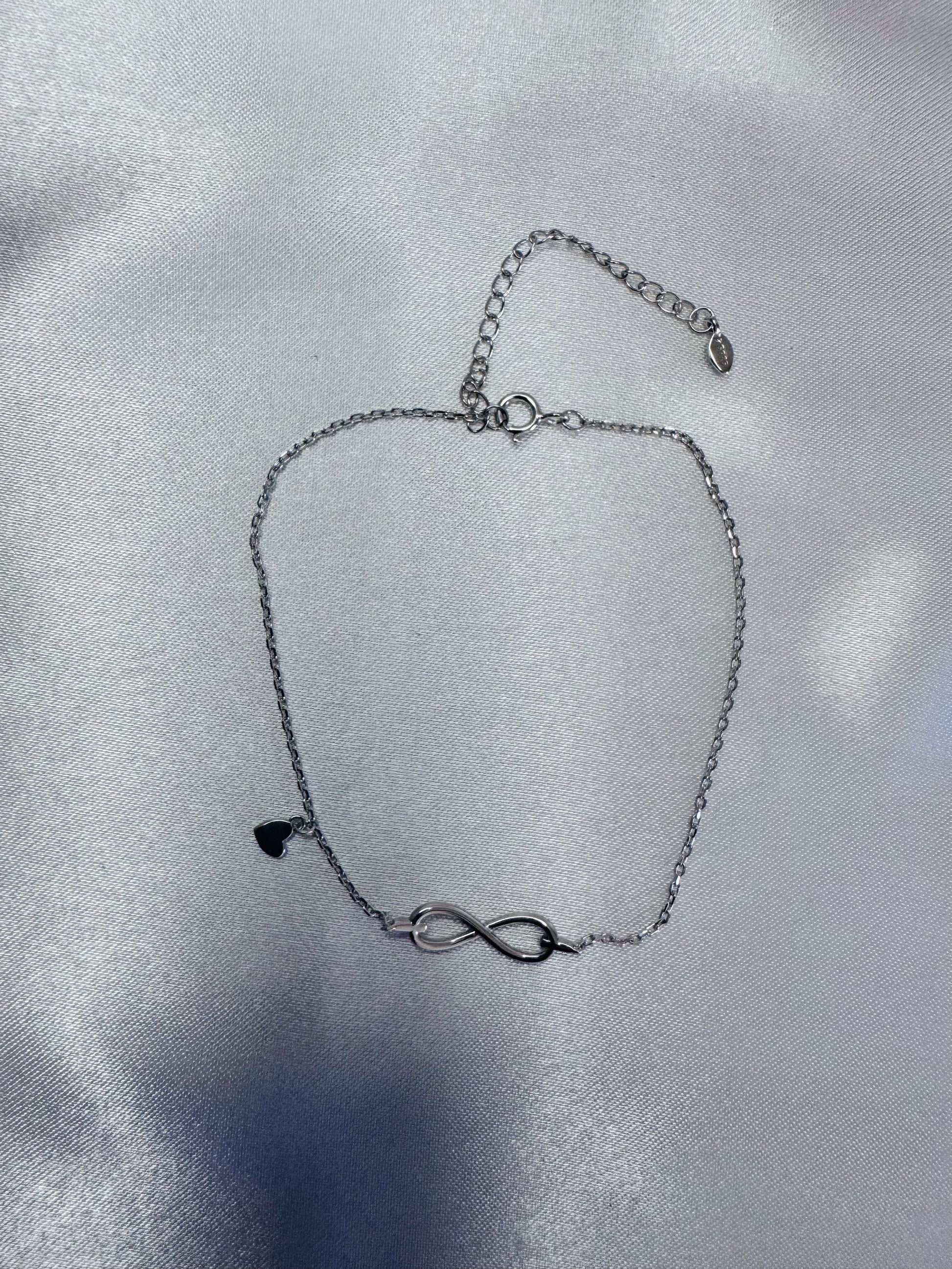 Silver bracelet with an infinity symbol on a silver background