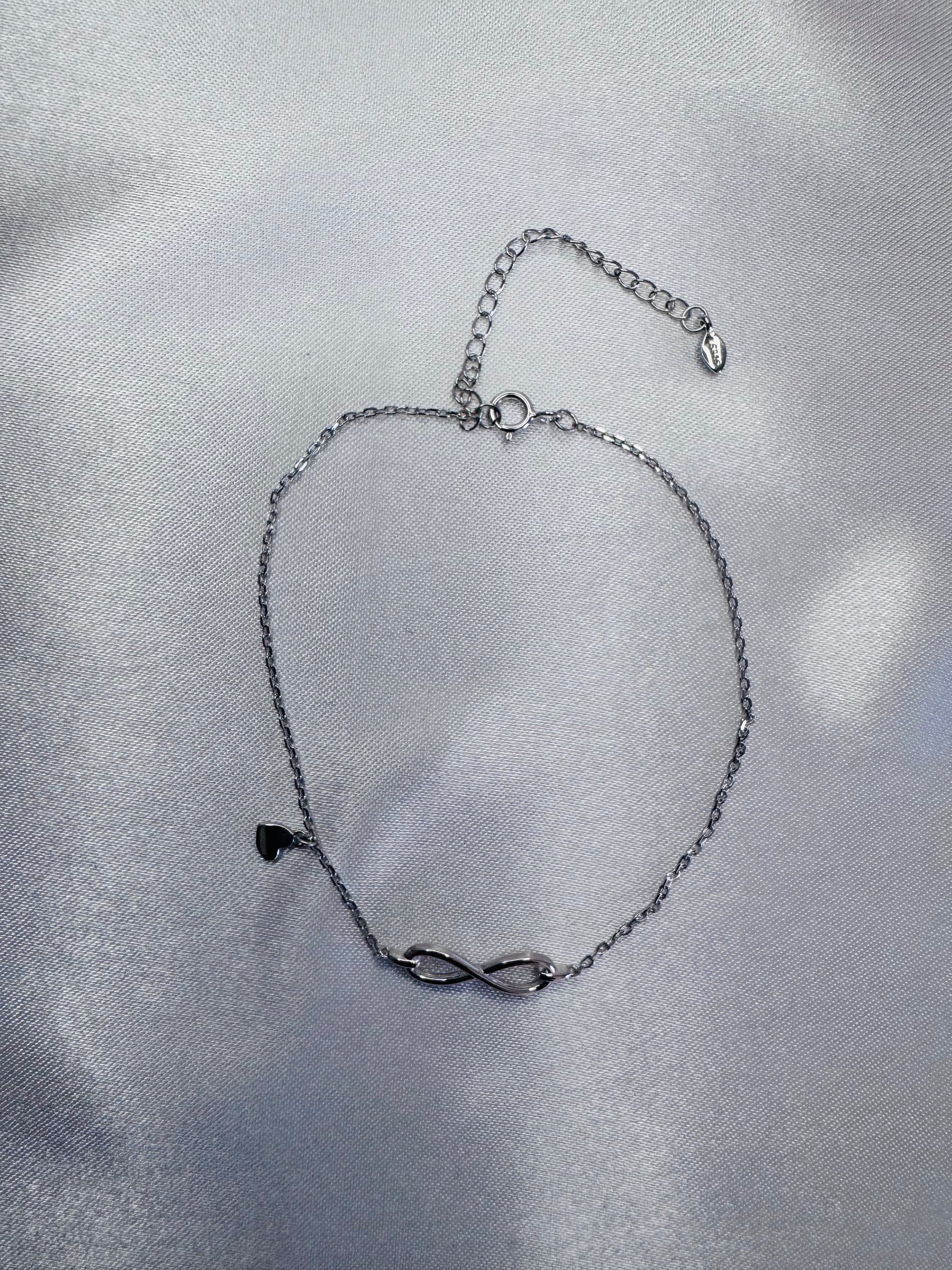 Silver bracelet on a gray fabric background