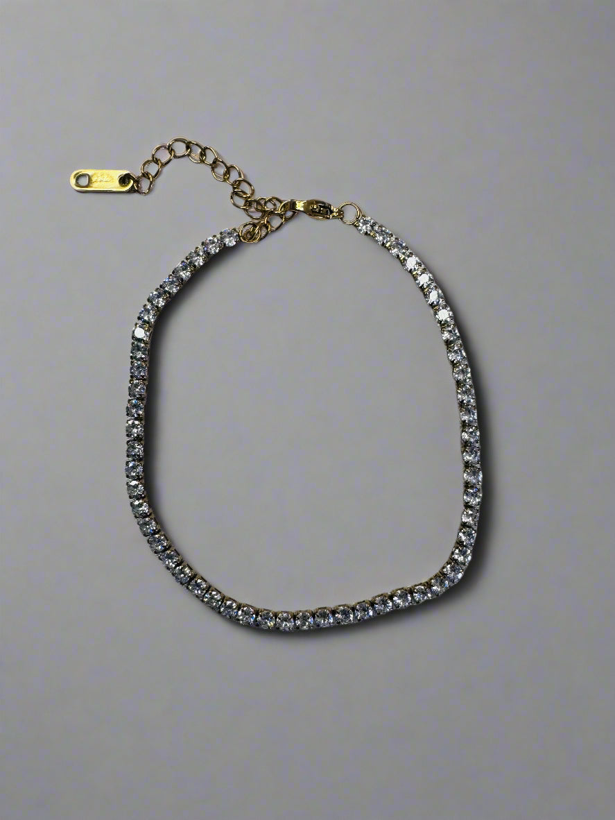 Bracelet with clear stones on a gray fabric background