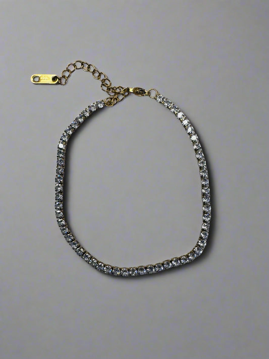 Bracelet with clear stones on a gray fabric background