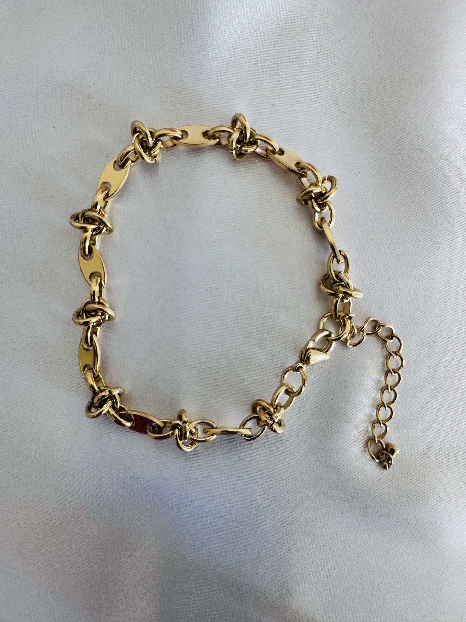 Gold chain anklet  on a light gray background