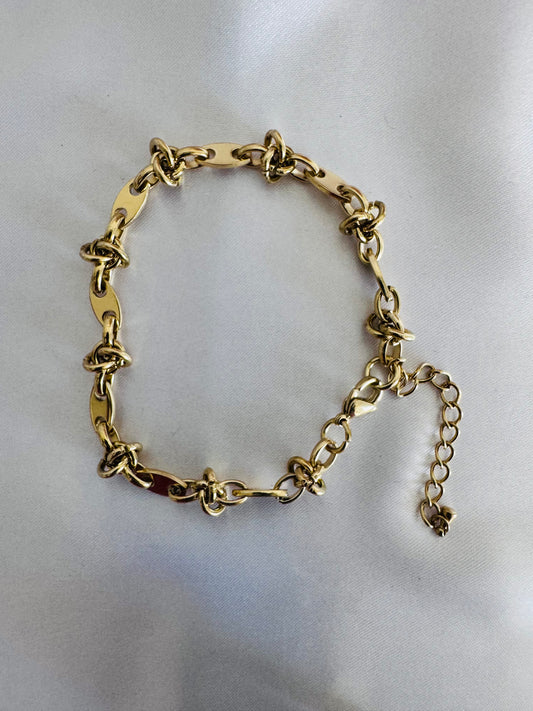 Gold chain anklet  on a light gray background