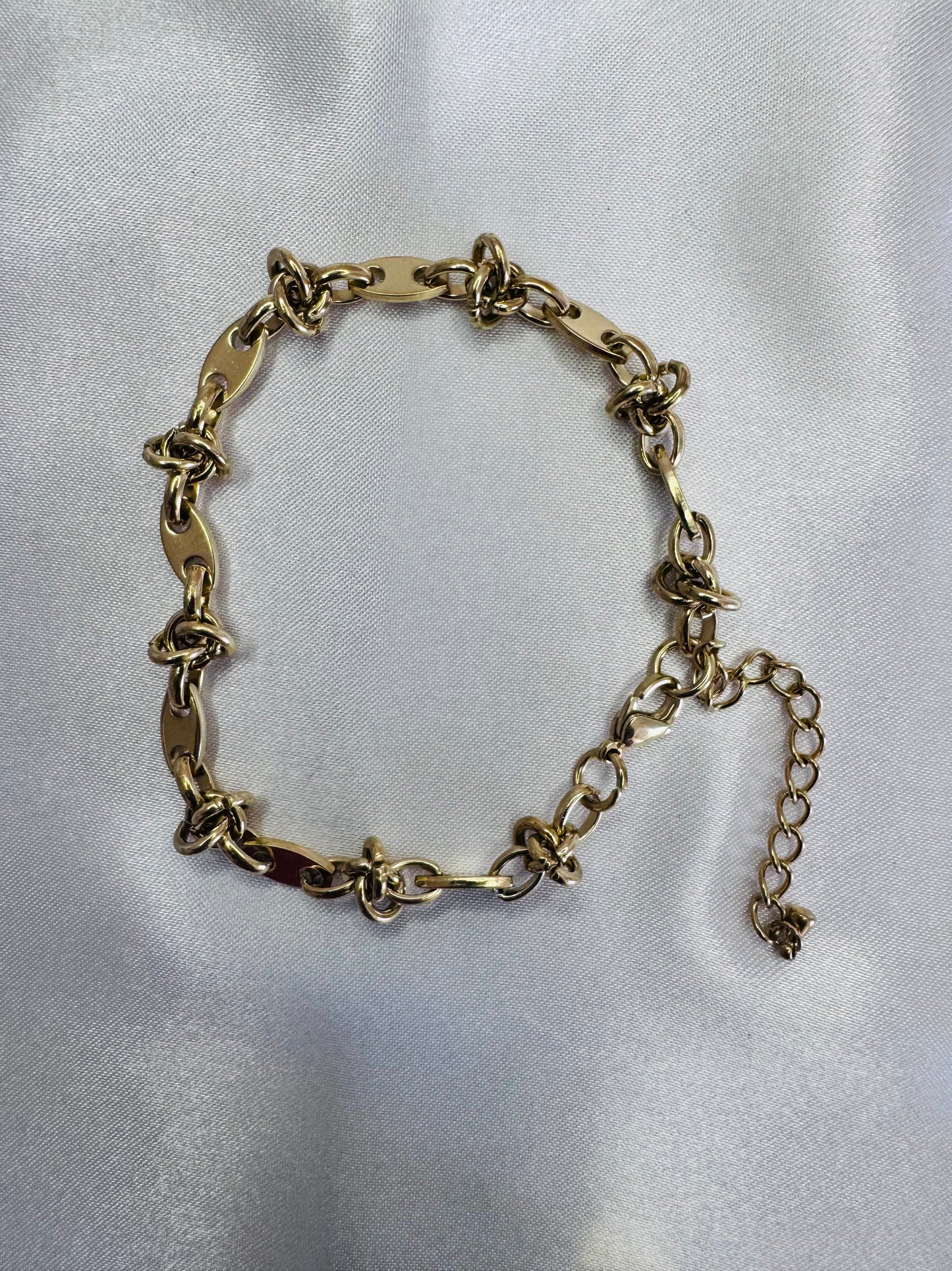 Gold chain anklet  on a light gray background