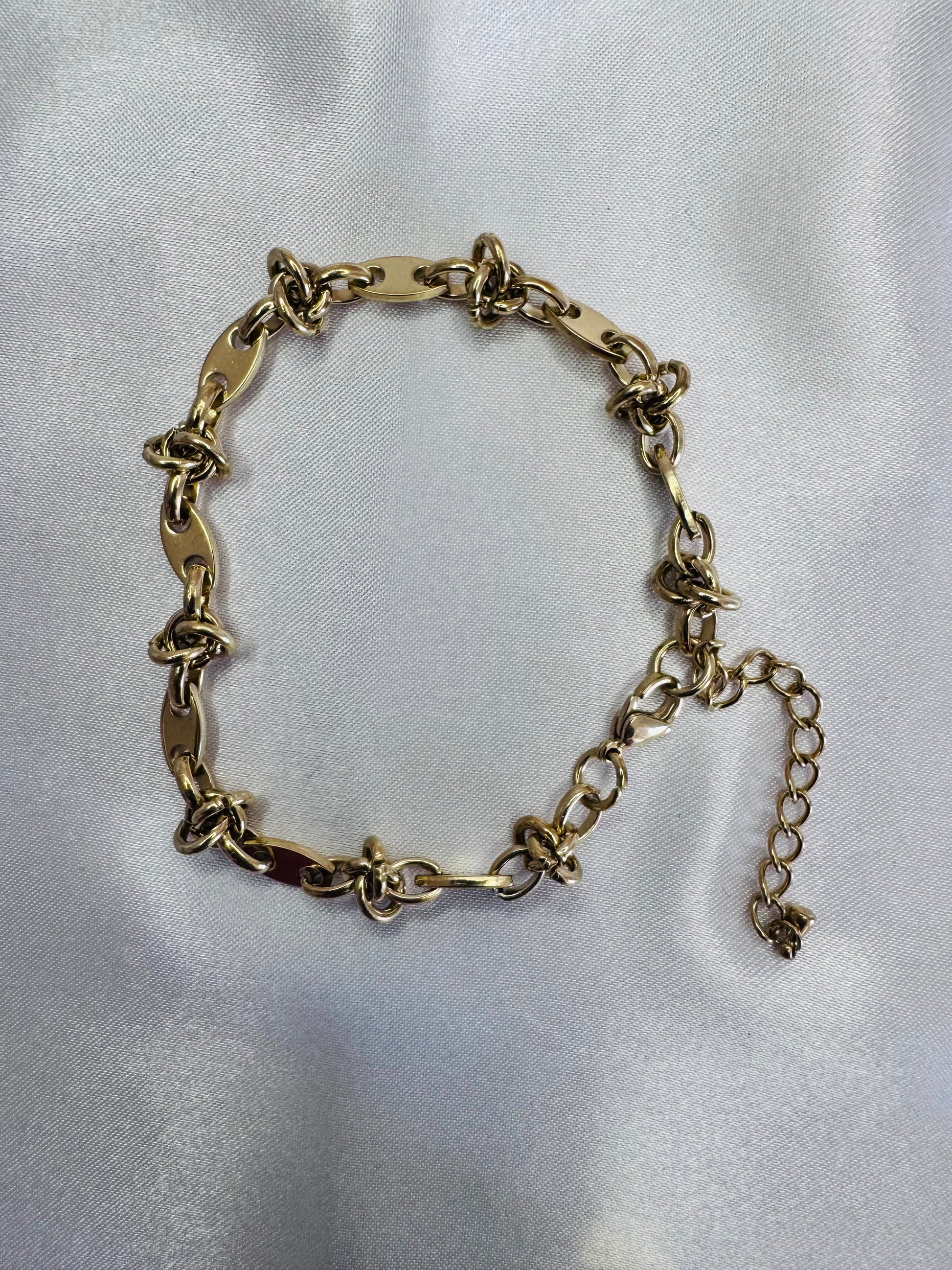 Gold chain anklet  on a light gray background