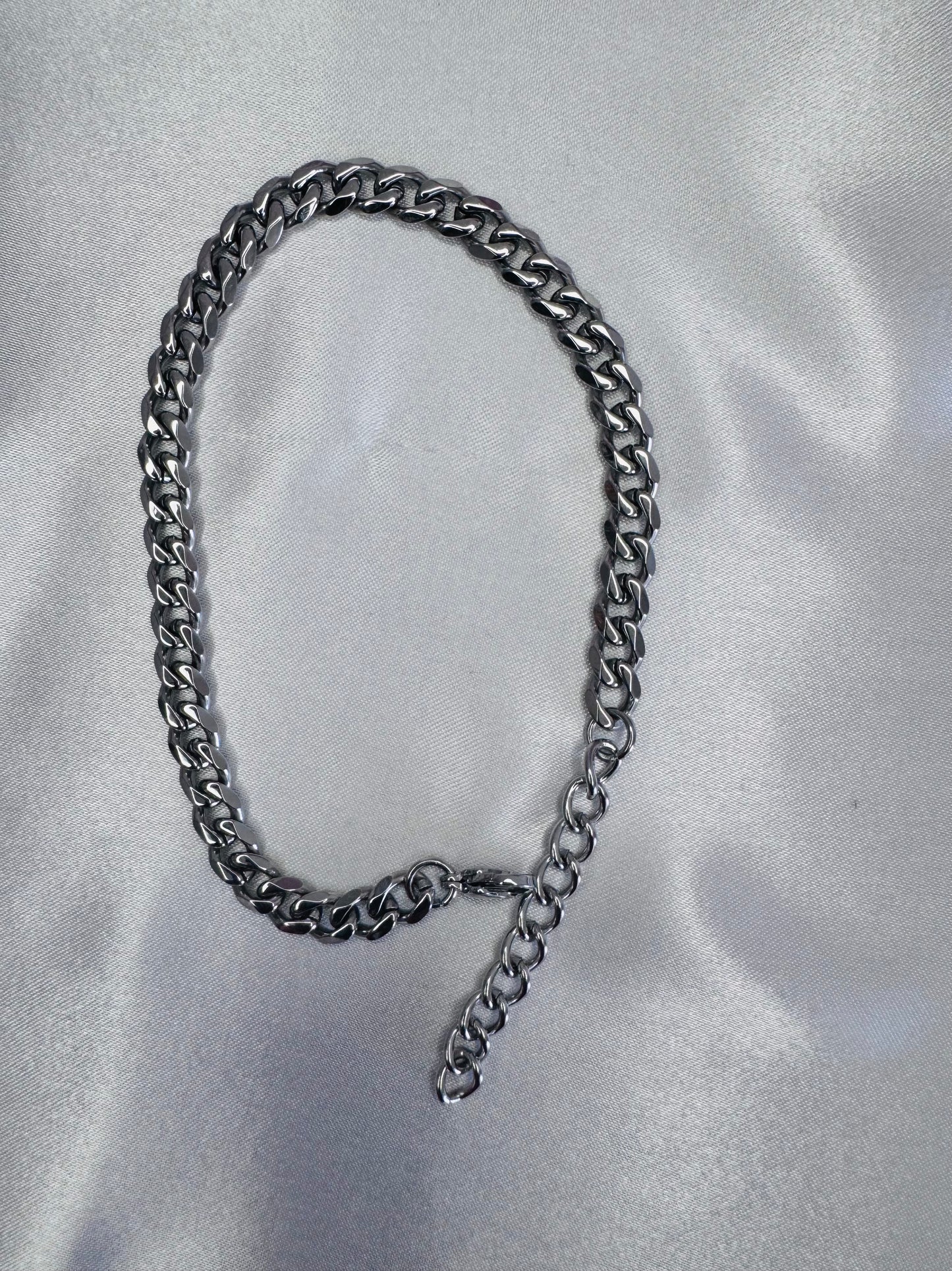 Silver anklet on a light gray background