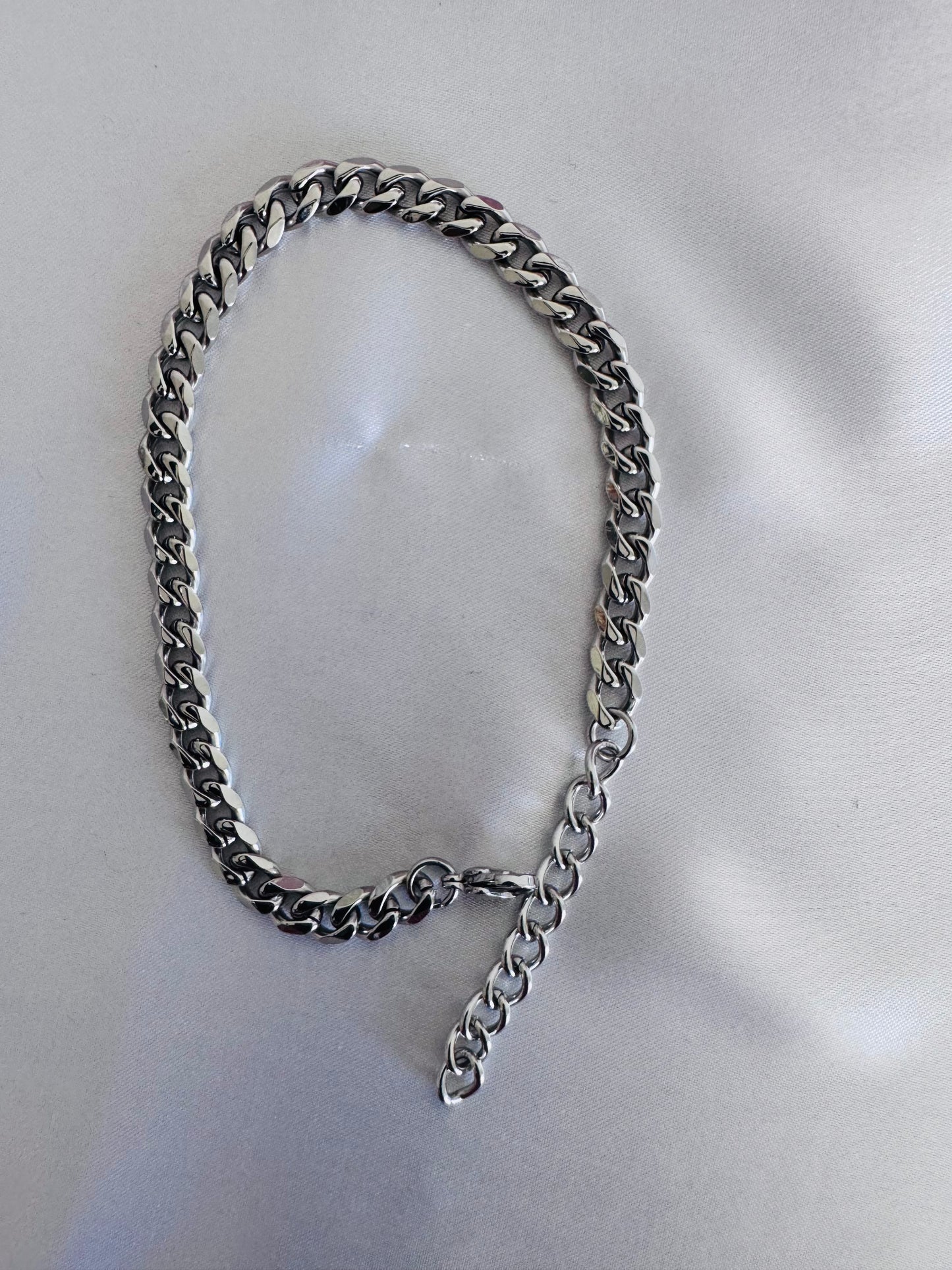 Silver anklet on with a white background