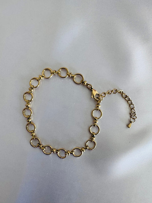Gold chain anklet  on a light gray background