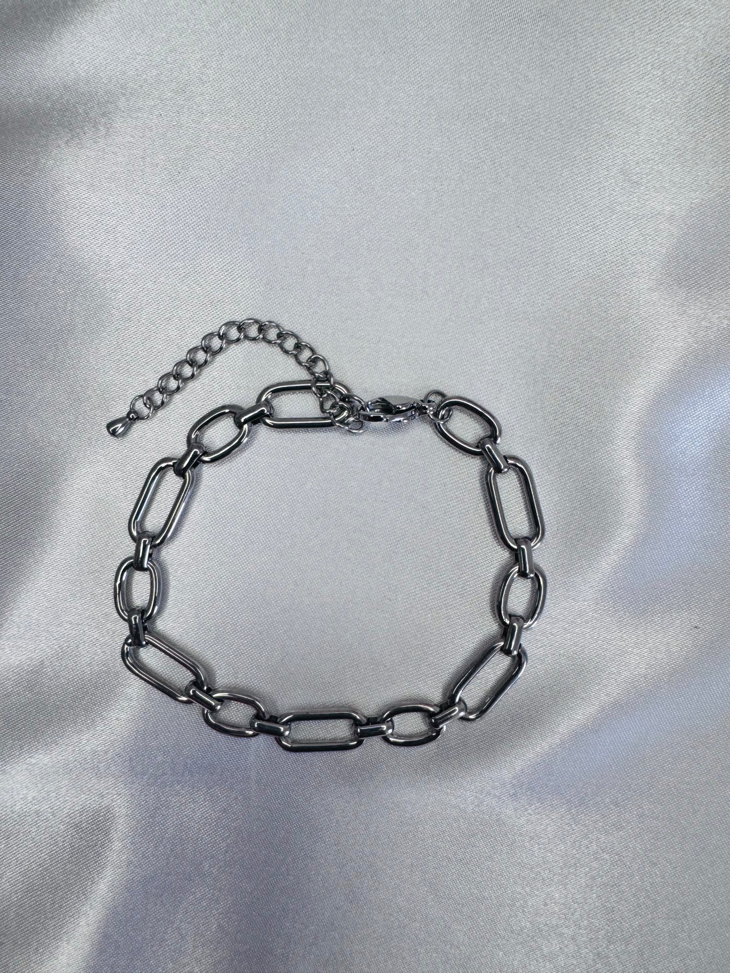 Silver chain anklet  on a silver satin background