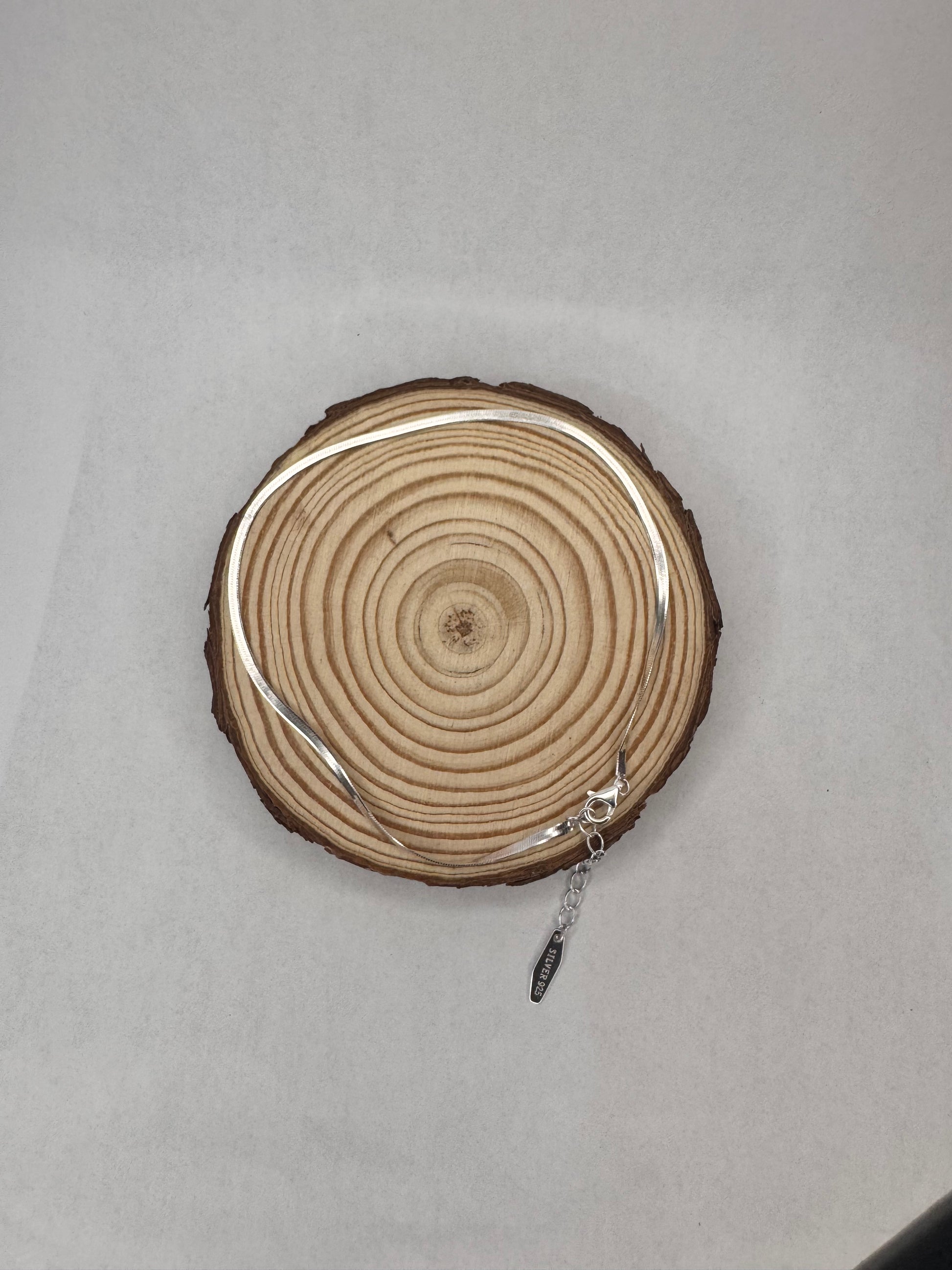 silver anklet on a wooden background