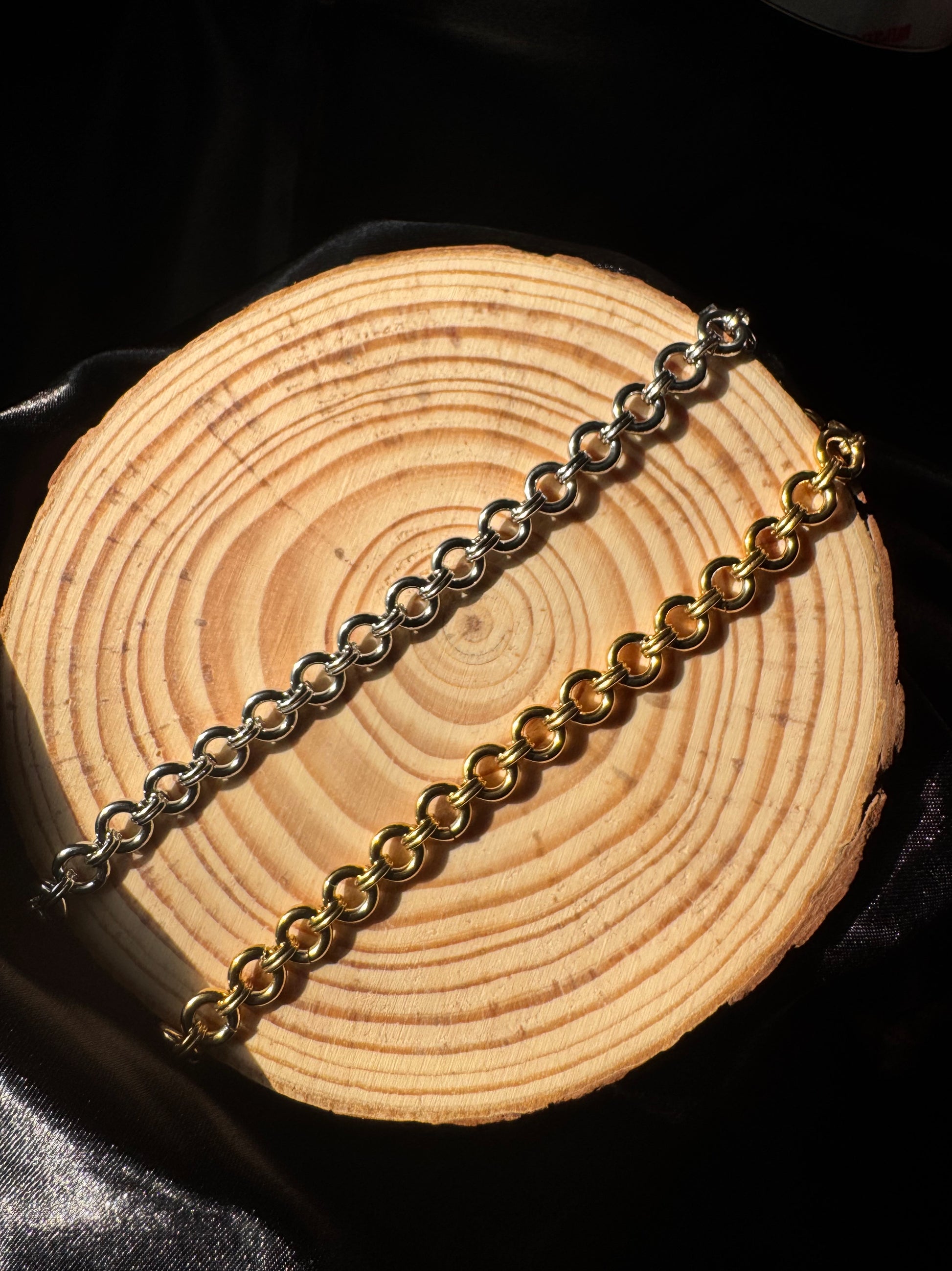 Gold and silver chain on a wooden surface