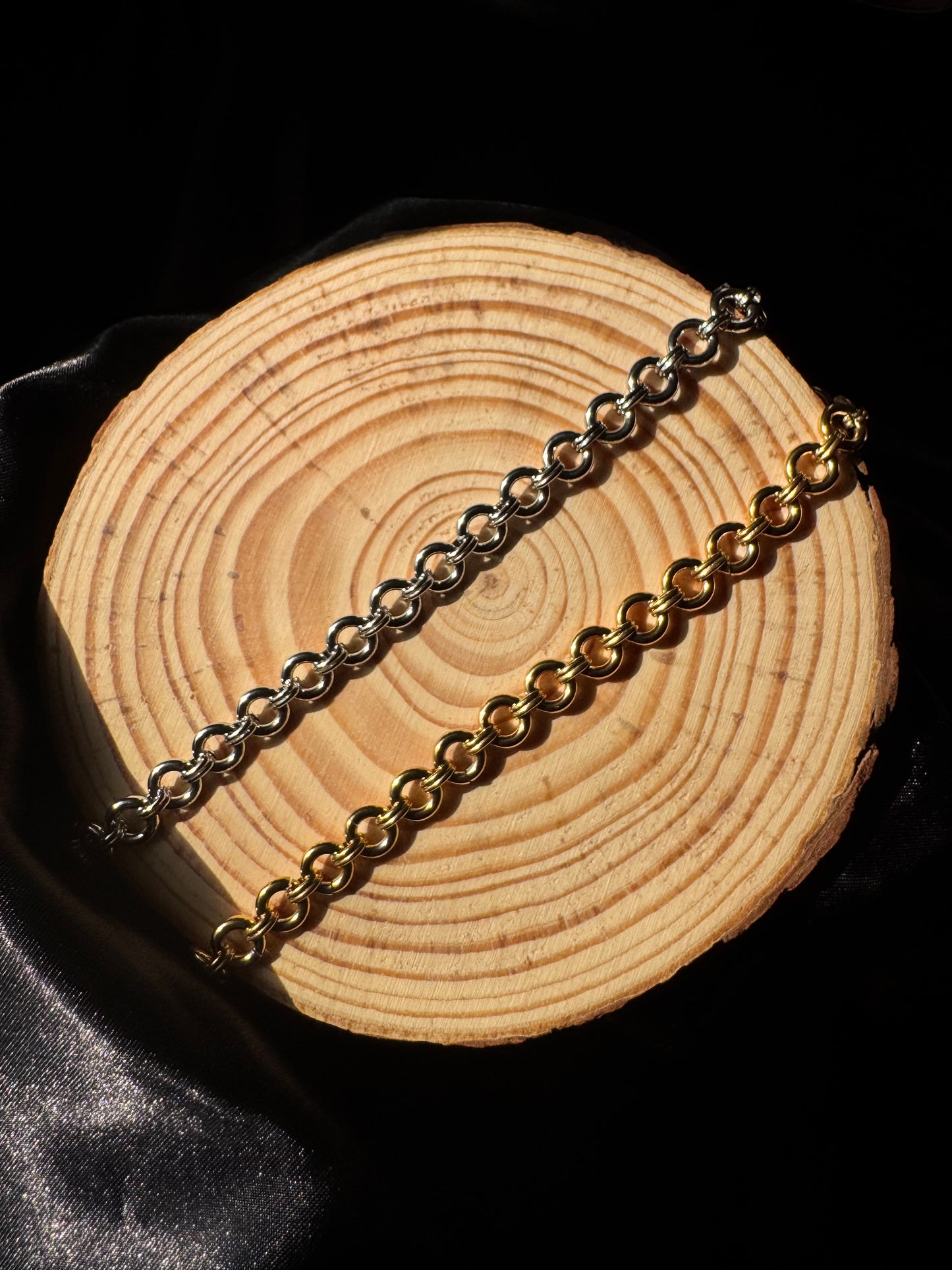 Gold chain on a wooden surface with a black background