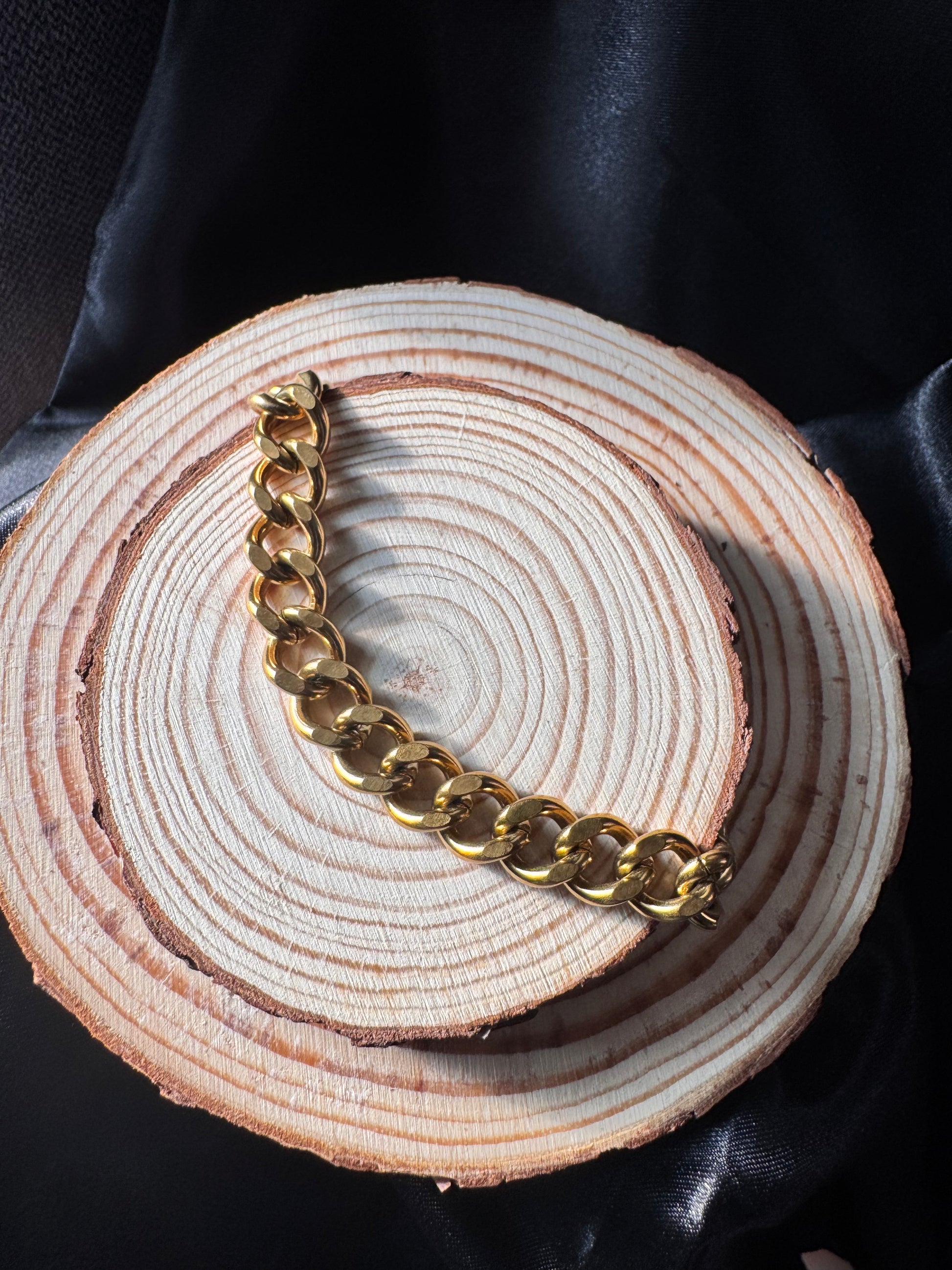 Gold chain  anklet on a wooden surface