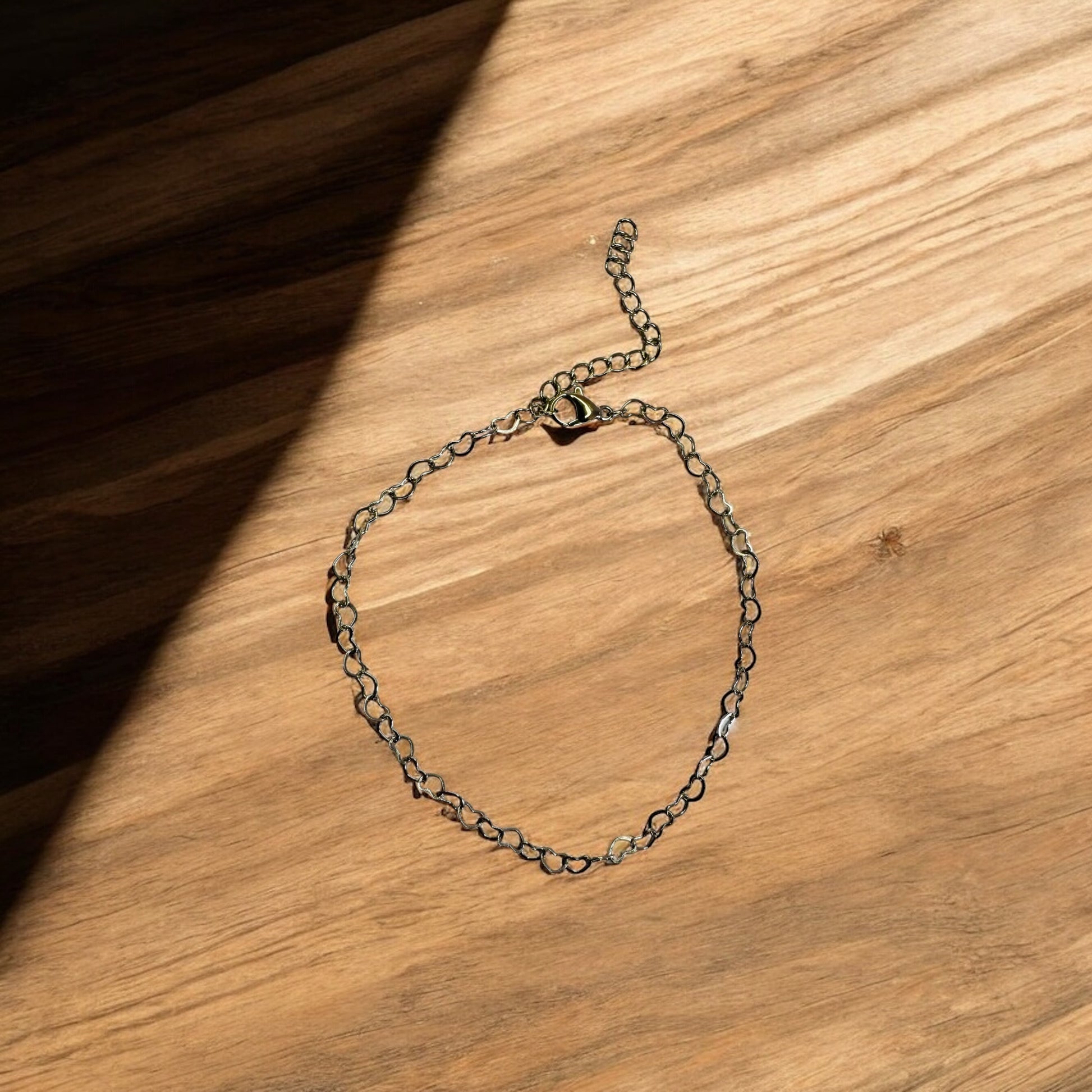 Silver chain bracelet on a wooden surface