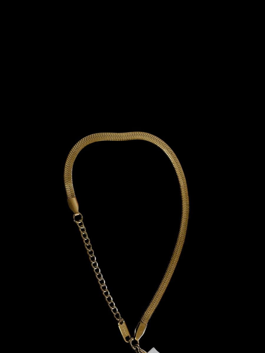 Gold chain necklace on a black background