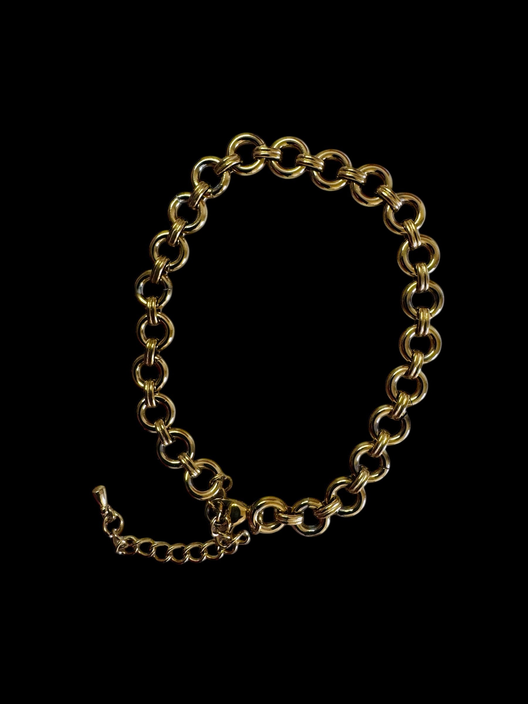 Gold chain bracelet on a black background