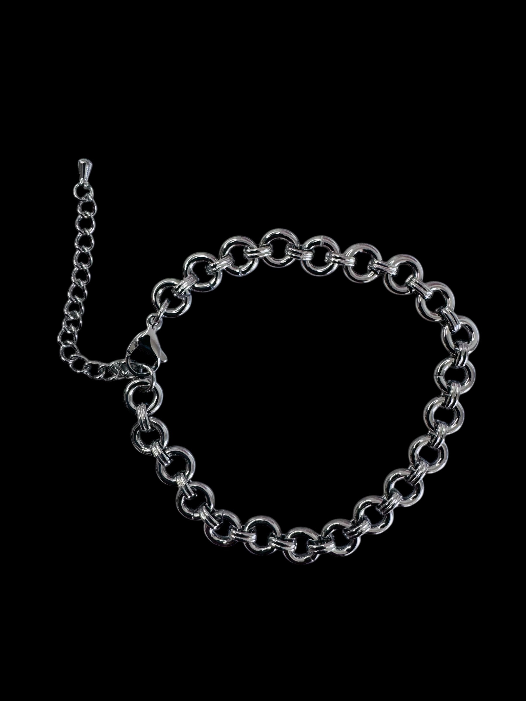 Silver chain bracelet on a black background