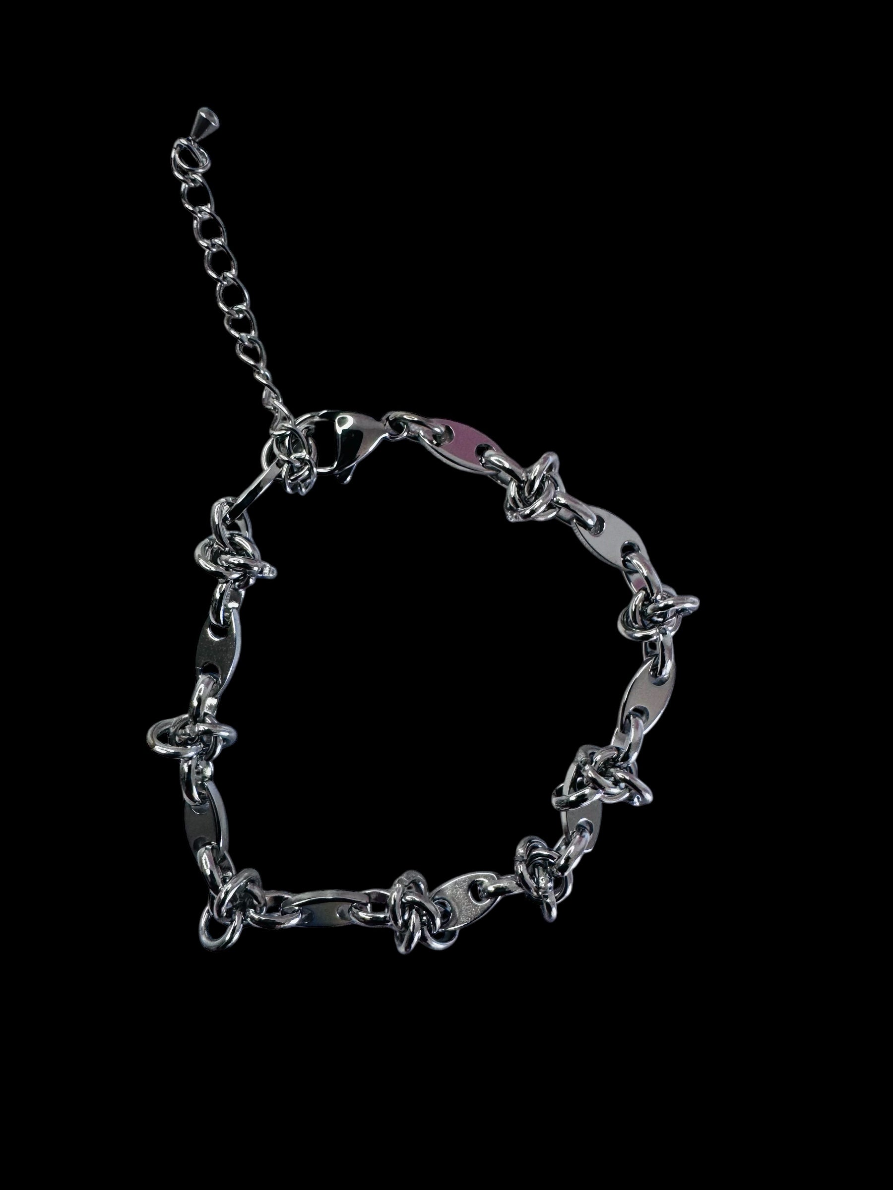 Silver chain anklet on a black background