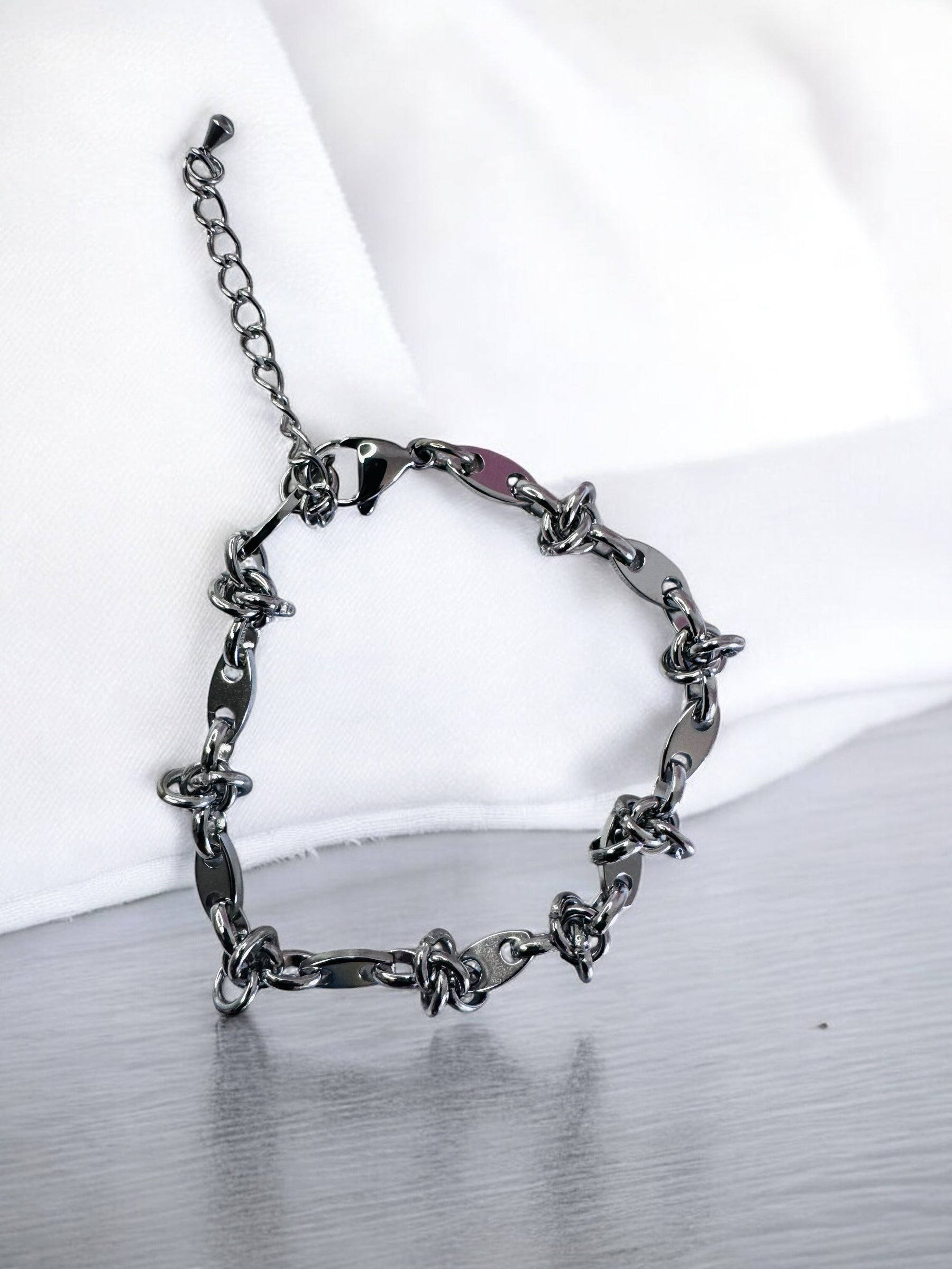 Silver chain anklet  on a white and gray gradient background