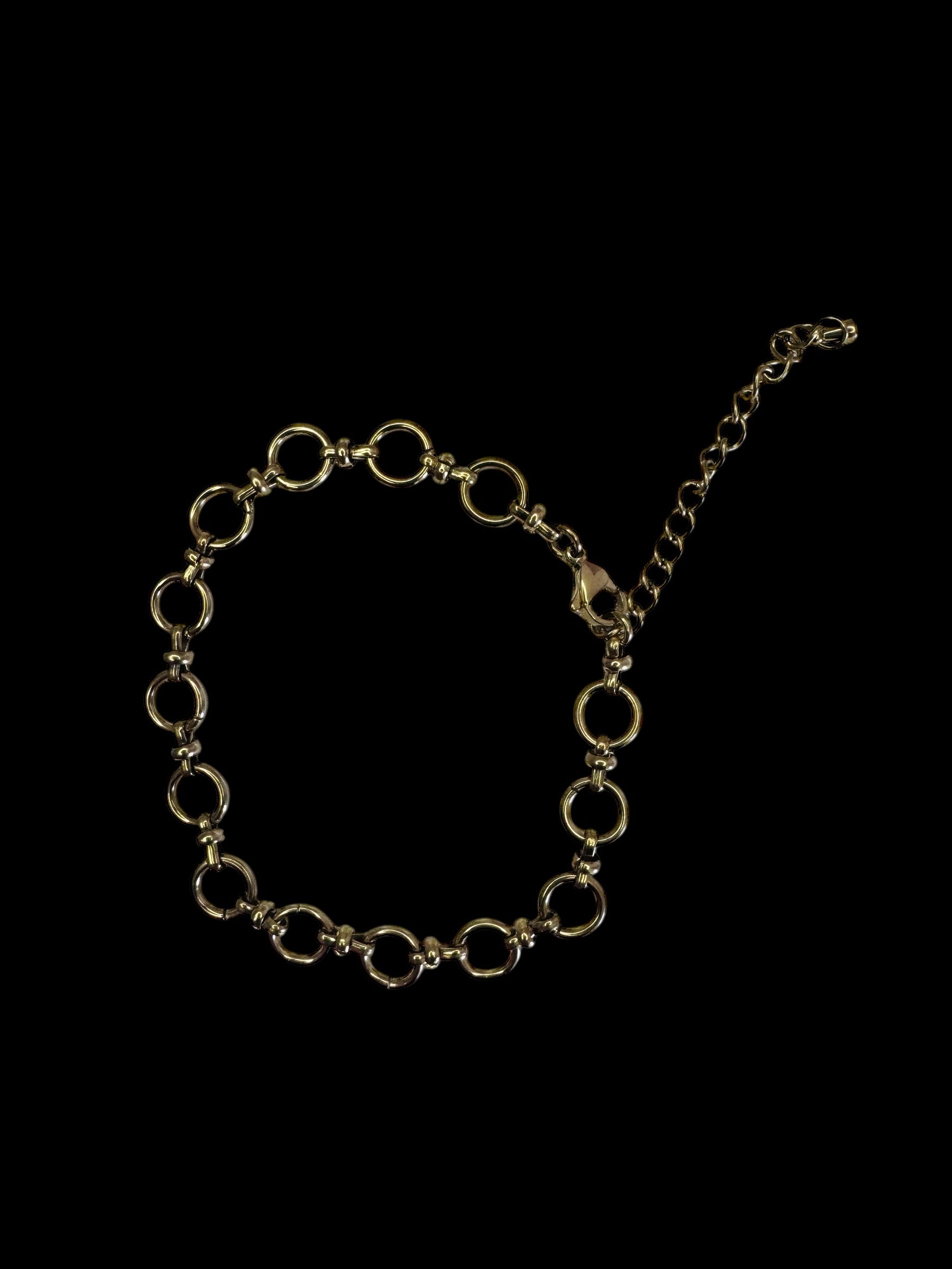 Gold chain anklet on a black background