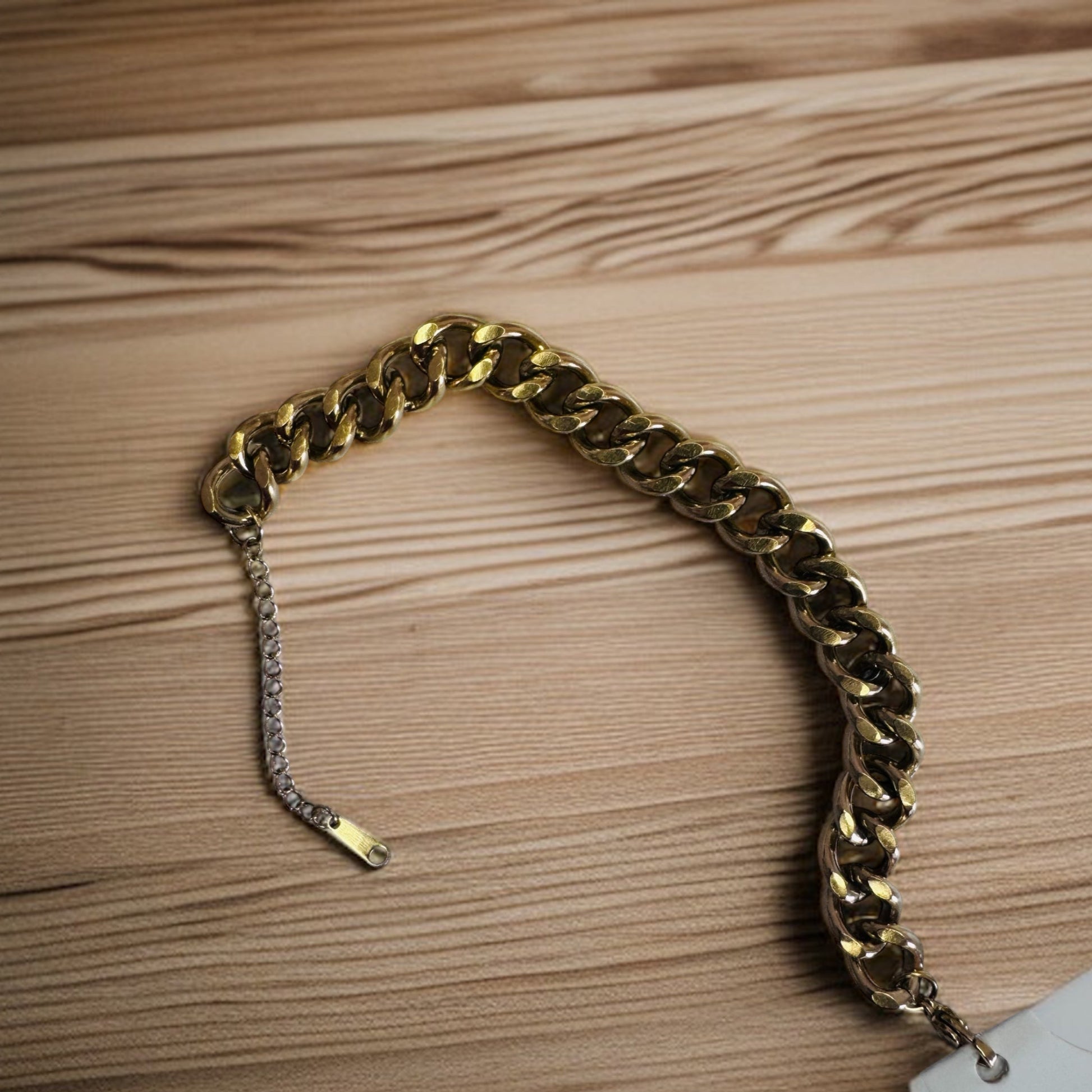 Gold chain  anklet on a wooden surface