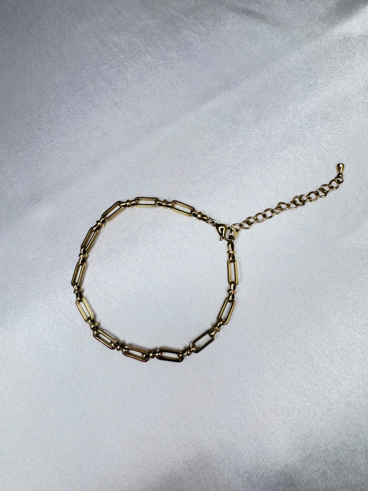 Gold bold link anklet on a light gray background