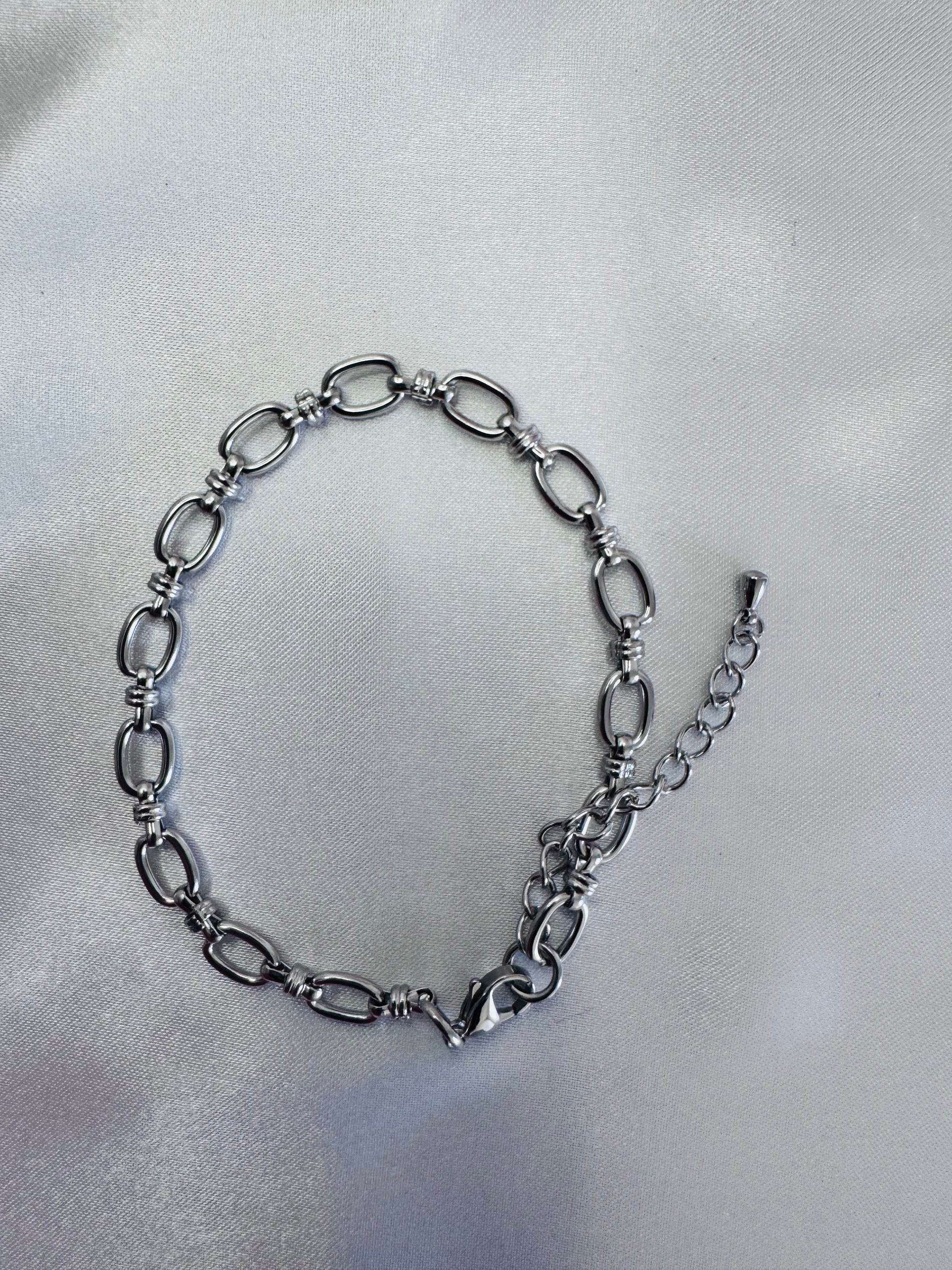 Silver anklet on a light gray background