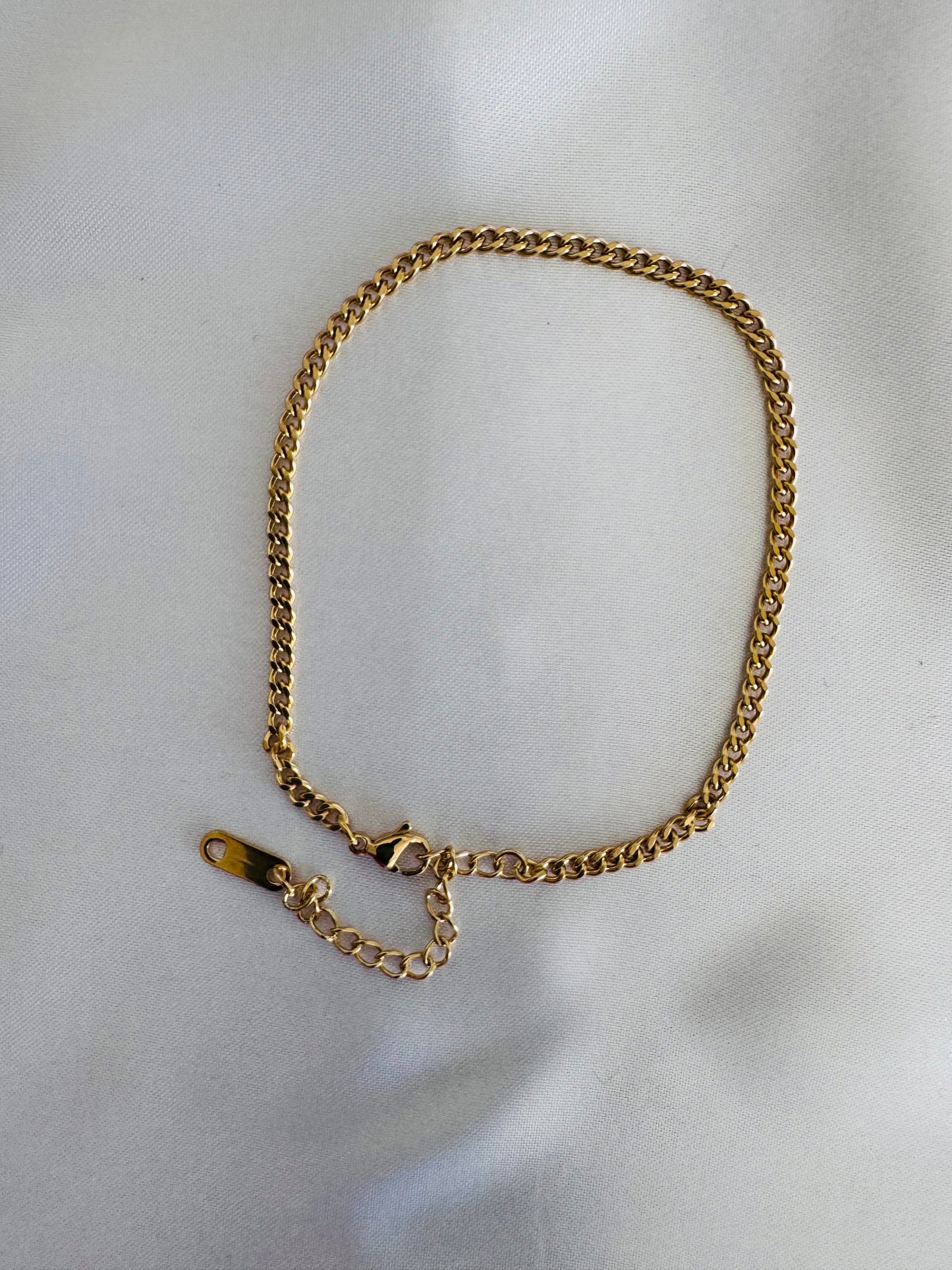 Gold chain anklet on a white background