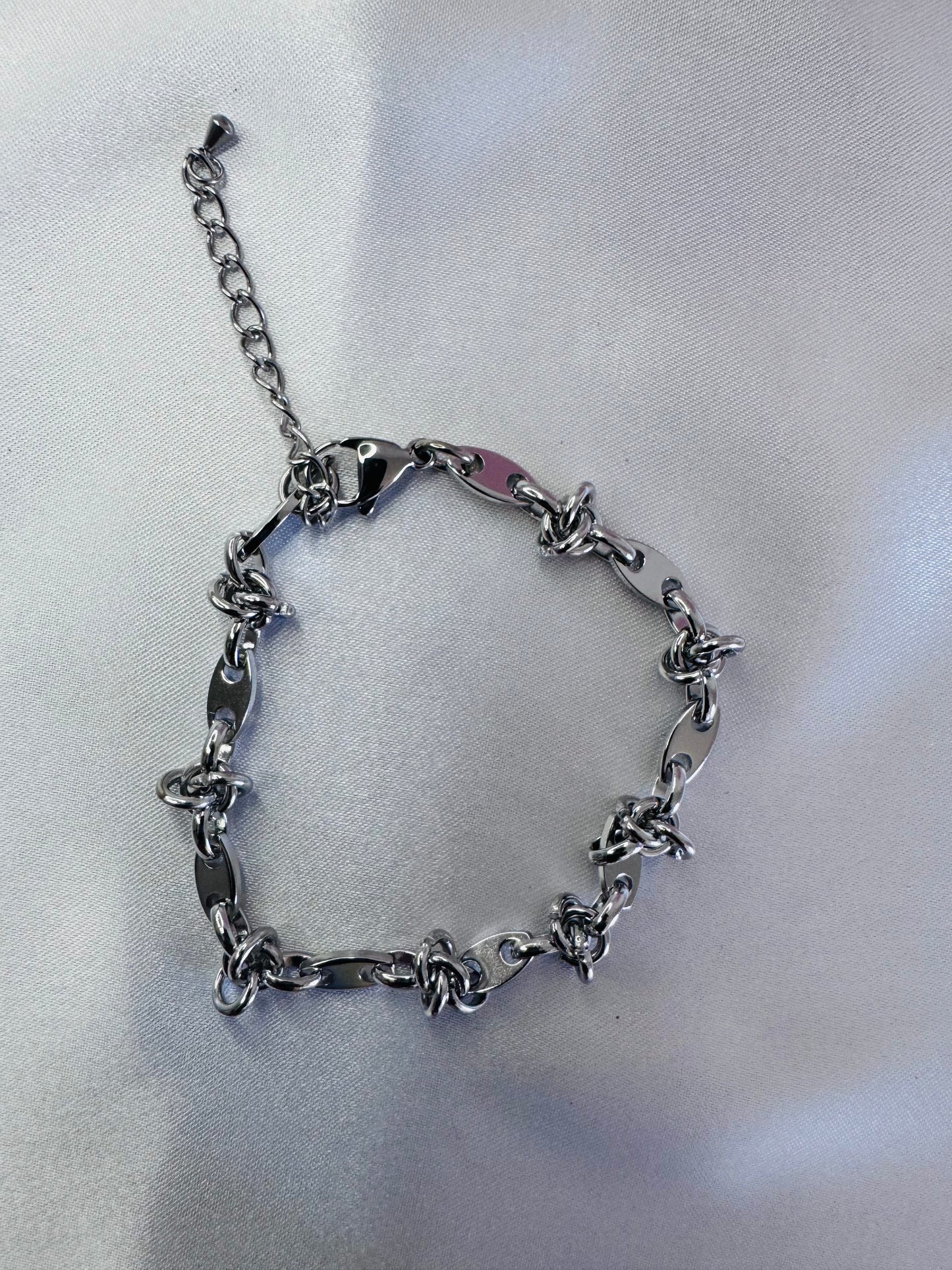 Silver chain anklet  on a light gray background
