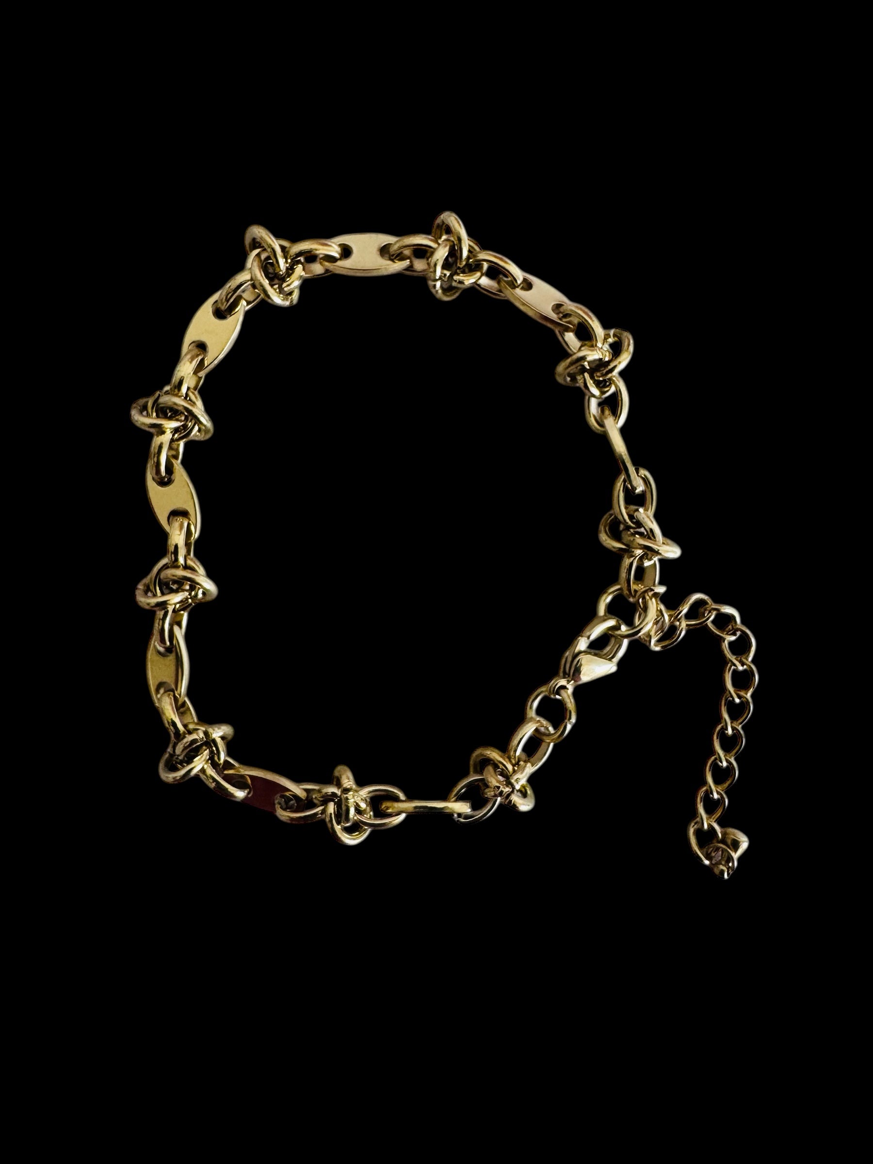 Gold anklet on a black background