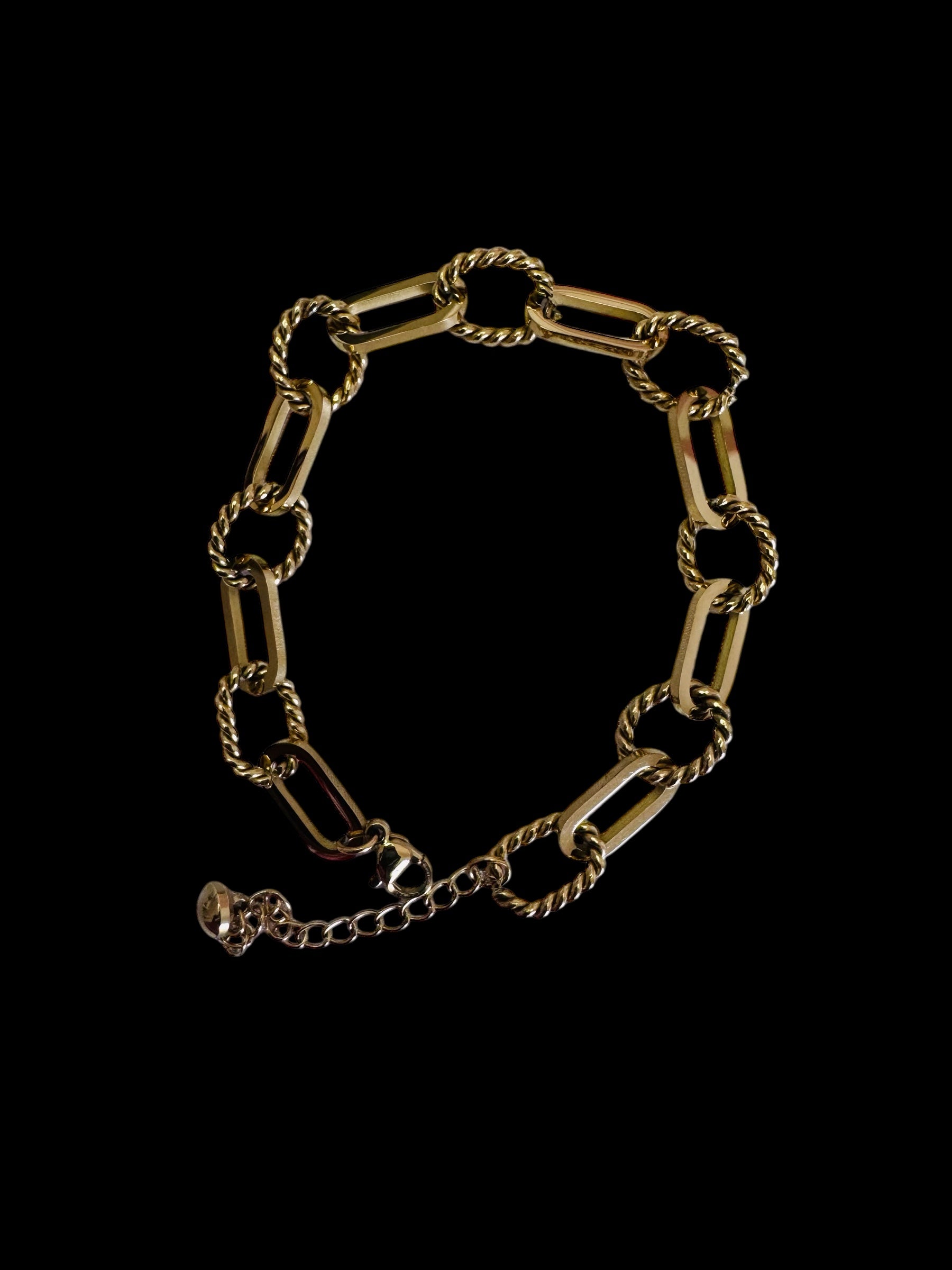 Gold rope anklet on a black background