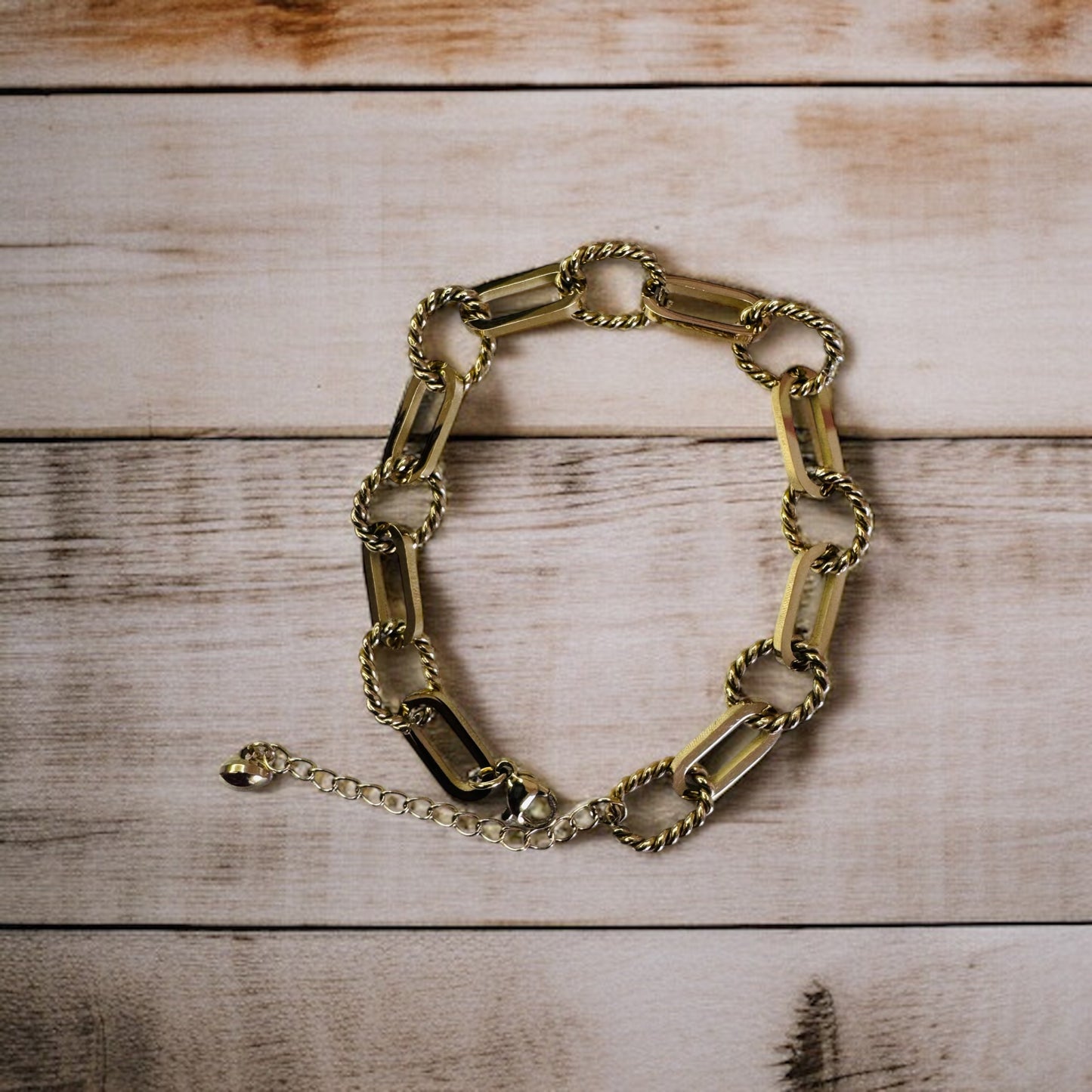 Gold rope anklet on a wooden surface