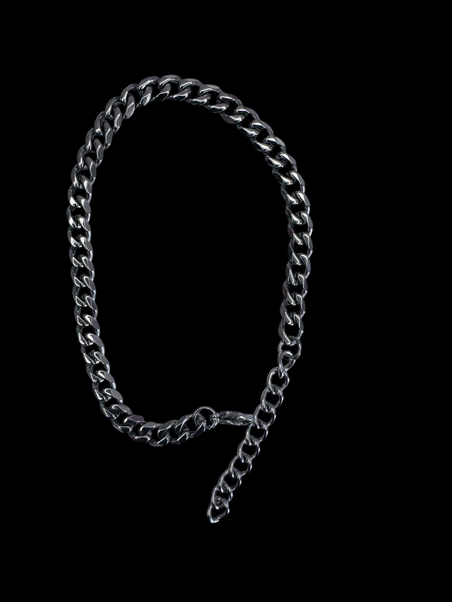 silver chain anklet on a black background
